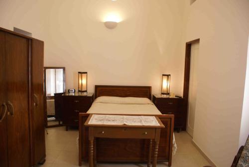 a bedroom with a bed and a table in it at Yiayia's House Limassol city in Limassol