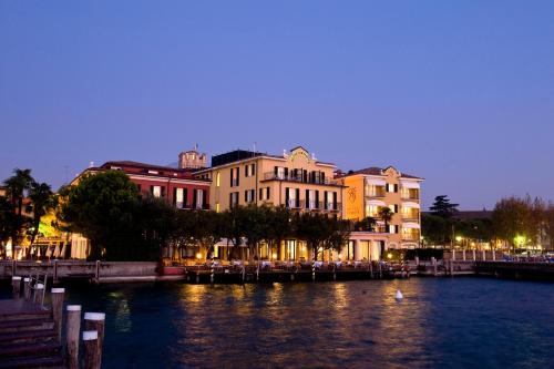 a view of a city with a river and buildings at Hotel Sirmione Terme in Sirmione