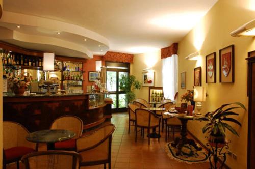 un restaurant avec un bar, des tables et des chaises dans l'établissement Hotel La Rocca, à Gubbio