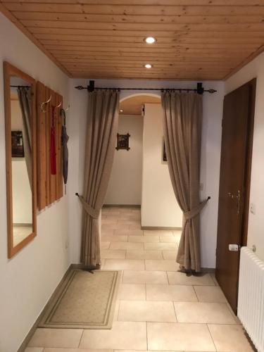 a hallway with curtains in a room with a tile floor at Haus Brengartner in Münstertal