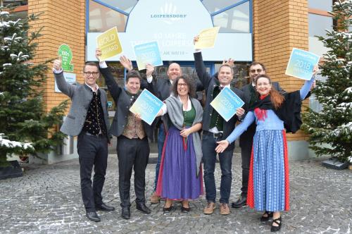 a group of people holding up signs in front of a building at Gmiatliche Stubm in Loipersdorf bei Fürstenfeld
