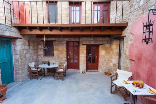 an outdoor patio with a table and chairs at Rodi in Rhodes Town