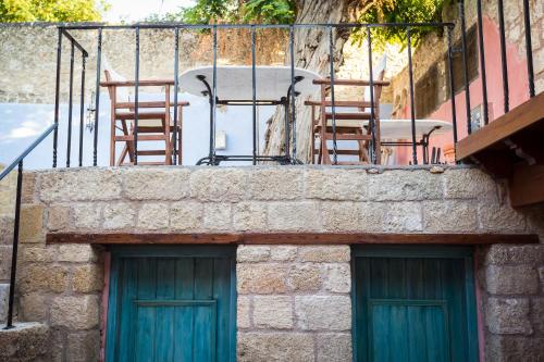 a patio with chairs and a table on a balcony at Rodi in Rhodes Town