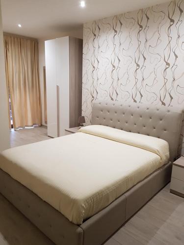 1 dormitorio con 1 cama blanca grande en una habitación en La Suite, en Cassino