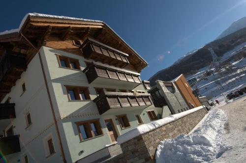 a building on the side of a mountain with snow at Residence Pedranzini in Bormio