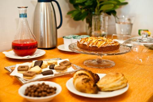 ein Tisch mit Brot, Kuchen und einem Teller Essen in der Unterkunft Masseria La Gravina in Palagianello