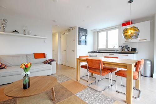 a kitchen and living room with a table and chairs at 2 bedroom loft near Rijksmuseum in Amsterdam