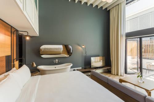 a bedroom with a large white bed and a window at Room Mate Emir, Istanbul in Istanbul