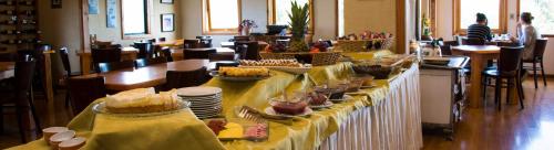 a long table with food on it in a restaurant at Hotel Borde Lago in Puerto Varas