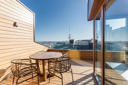 a patio with a table and chairs on a balcony at Room Mate Emir, Istanbul in Istanbul
