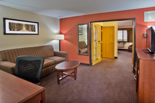 a living room with a couch and a table at AmericInn by Wyndham Grand Forks in Grand Forks