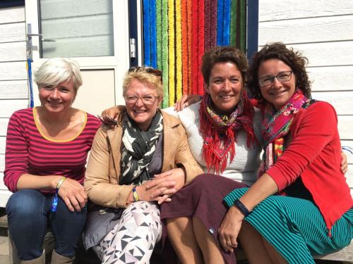 a group of three women sitting on a porch at Chalet Kocky in Midsland