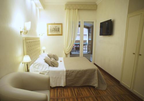 a hotel room with a bed and a chair at Locanda Navona in Rome