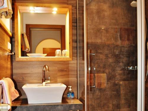 a bathroom with a sink and a shower at Gästehäuser Schwemmbauer in Reit im Winkl