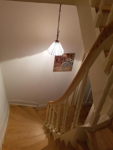a staircase with a light hanging from a ceiling at Guest House Dasos Kynthos in Brussels