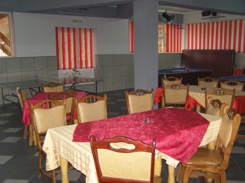 a dining room with a red table and chairs at El Stefano Srl in Cavnic