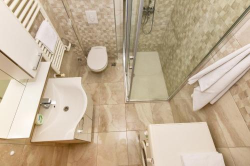 a bathroom with a shower and a toilet and a sink at Apartments Marieta in Makarska