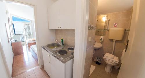 a small bathroom with a sink and a toilet at Beach Hotel in Drasnice