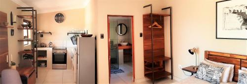 two pictures of a kitchen with a refrigerator and a room at Graceland Eco Retreat in Magoebaskloof