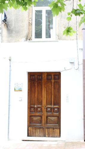 a wooden door on the side of a building at La Terrazza sul Mare in Ascea