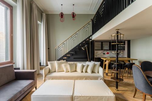 a living room with a couch and a staircase at Room Mate Emir, Istanbul in Istanbul