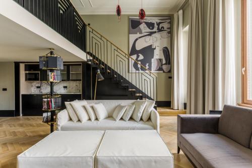 a living room with two couches and a staircase at Room Mate Emir, Istanbul in Istanbul