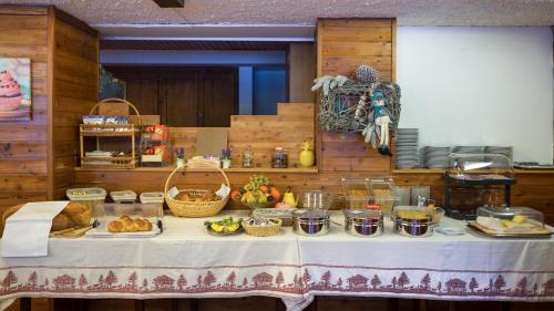 a table with bread and other food on it at Hotel La Prairie in Crans-Montana