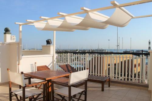 a patio with a table and chairs on a balcony at Residence Fiorella in Cattolica