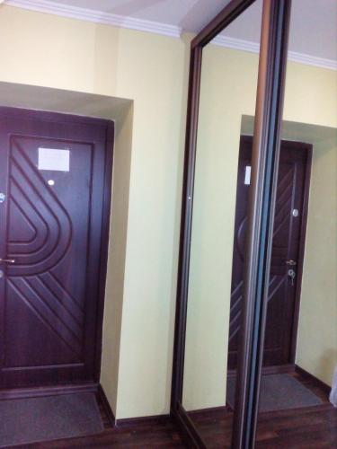 two mirrors in a room with two doors at В центрі за драмтеатром. in Ivano-Frankivsʼk