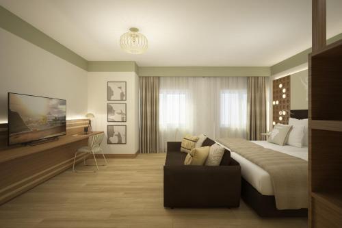 a hotel room with a bed and a couch at Best Western Plus Soave Hotel in San Bonifacio