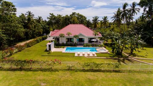 an aerial view of a house with a swimming pool at Bohol White House Bed & Breakfast in Lila