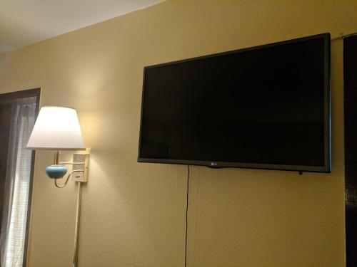 a flat screen tv hanging on a wall at Lakeview Motel in Lake Isabella