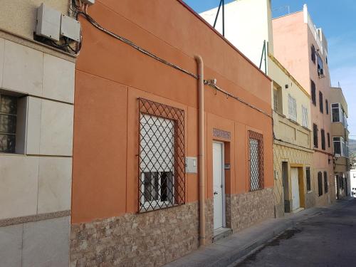an orange building with a window on a street at Apartamentos Villajovita in Ceuta