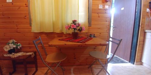 a room with a wooden wall with a table and chairs at kinneret love sounds in Migdal