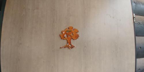 a wooden tree decoration on a wall at kinneret love sounds in Migdal