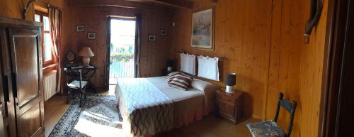 a bedroom with a bed in a wooden room at Maison Demetrio - Family Farm in Bossolasco