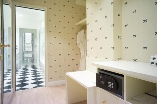 a bathroom with a black and white checkered floor at Turin Palace Hotel in Turin