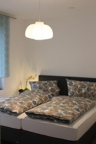 a bed with a comforter and pillows on it at Ferienwohnung in der Rhön Sitzmann in Bischofsheim an der Rhön