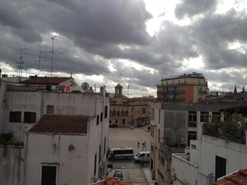 a view of a city with buildings and a cloudy sky at Bed&Breakfast JSuite in Gioia del Colle