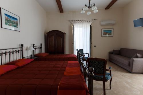 Letto o letti in una camera di B&B Batarà - "La Terrazza del Centro"