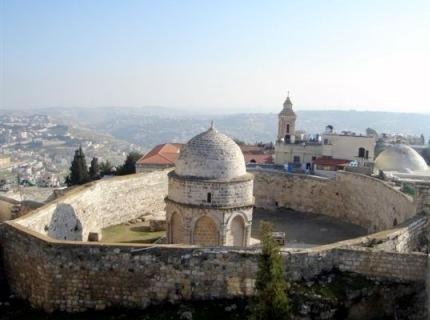 a building on top of a stone wall at Mount of Olives Hotel in Jerusalem