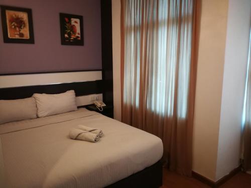 Łóżko lub łóżka w pokoju w obiekcie Hotel Economy Kapar