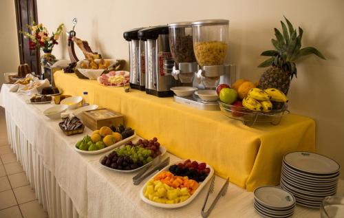 a buffet with fruits and vegetables in bowls on a table at Hotel Victoria Plaza in Tarija