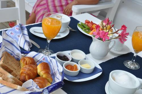 a table with a breakfast of croissants and orange juice at Kalá Hotel Boutique in Punta del Este