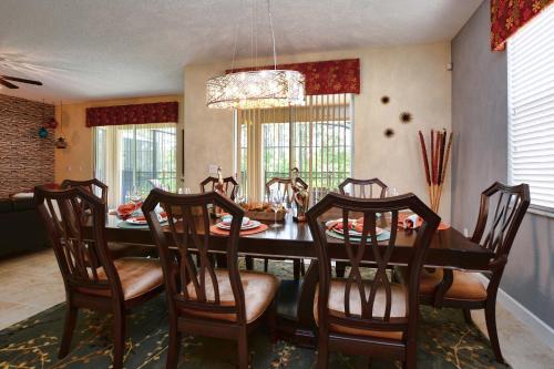a dining room with a table and chairs at DISNEY area Luxurious House-Private Pool in Kissimmee
