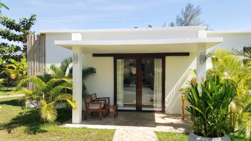 a small white house with a table and chairs at Sahaa Beach Resort in Sihanoukville