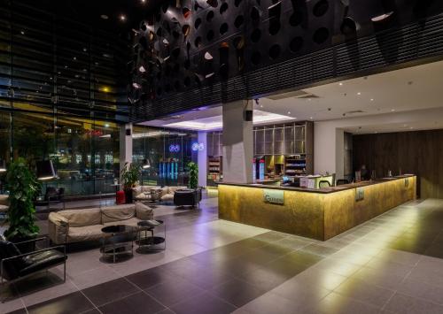 a lobby of a hotel with a reception desk at Tune Hotel KLIA-KLIA2, Airport Transit Hotel in Sepang