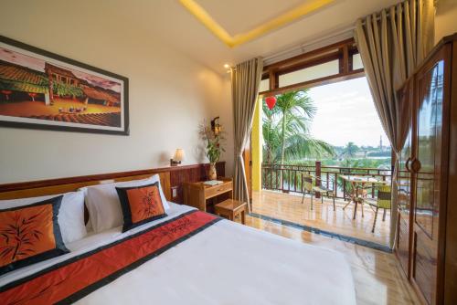 a bedroom with a bed and a balcony at Lakeview Villa Homestay in Hoi An
