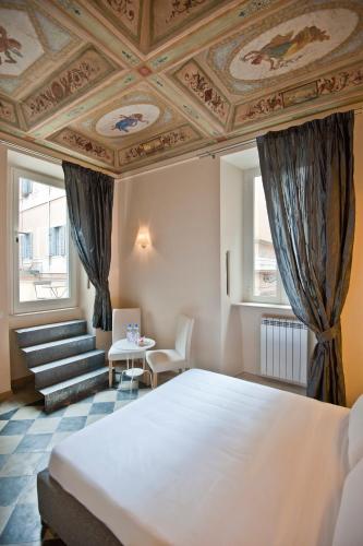 a bedroom with a large bed with a coffered ceiling at Little Queen Suite in Rome