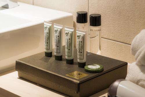 a group of four toothbrushes sitting on a holder in a bathroom at Reborn Suwon Silkroad Hotel in Suwon